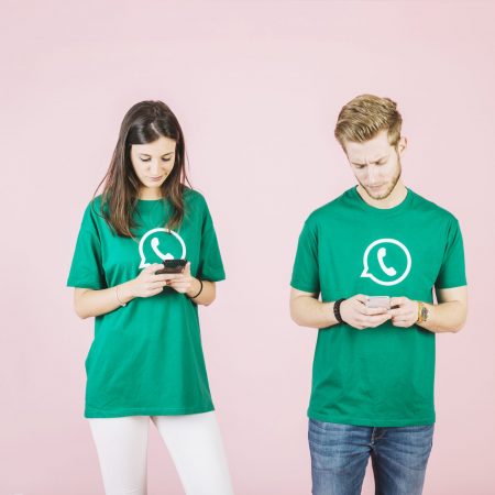 young-man-woman-using-mobile-phone-pink-background